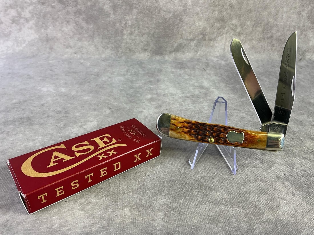 Case XX Knife: Case XX brown bone knife. Trapper, patterned 6254ss, with tight snap and original box. Box measures 4.5 wide x 1.75 inches tall.