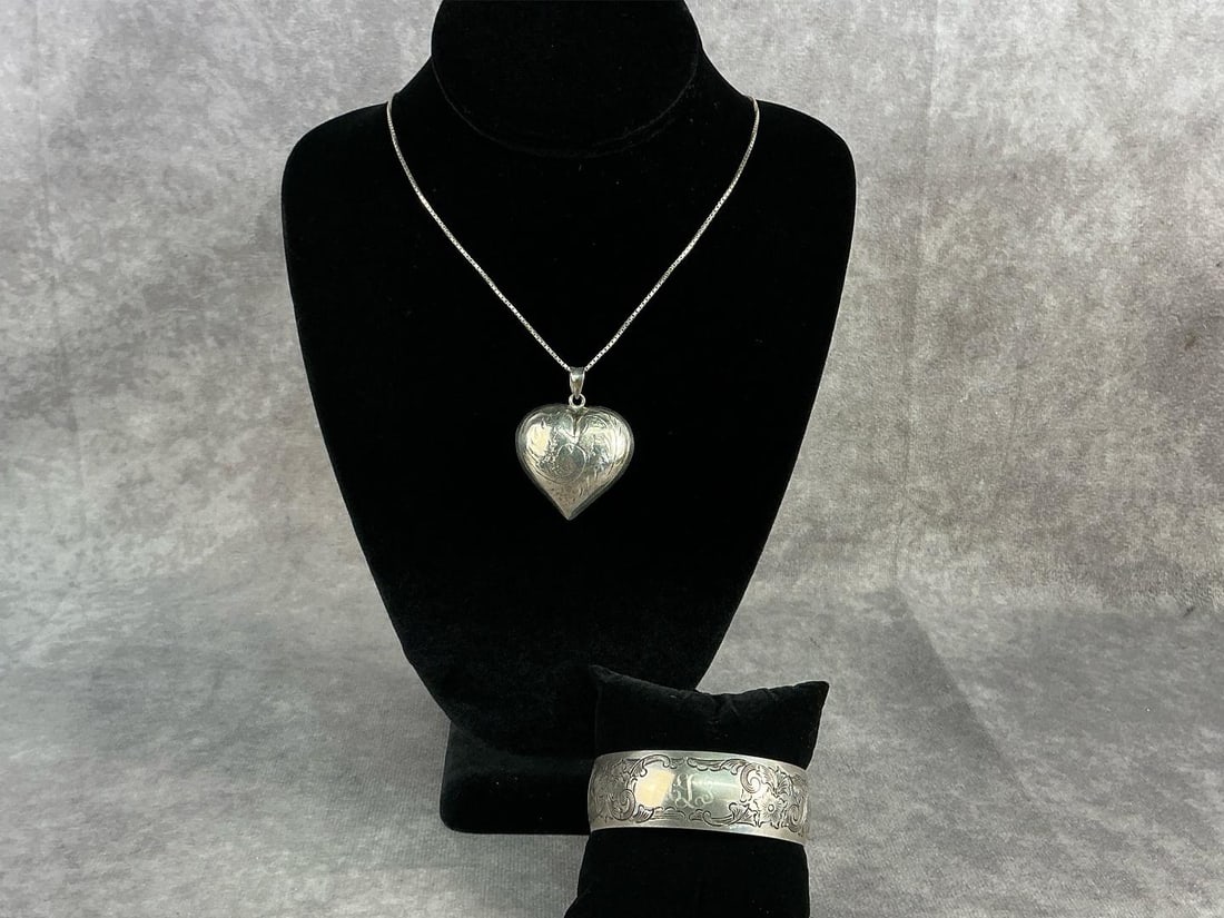 Sterling Silver Jewelry: Sterling silver bangle bracelet and heart pendant on chain. Both in good condition and stamped. Total weight 1.78 ozt.