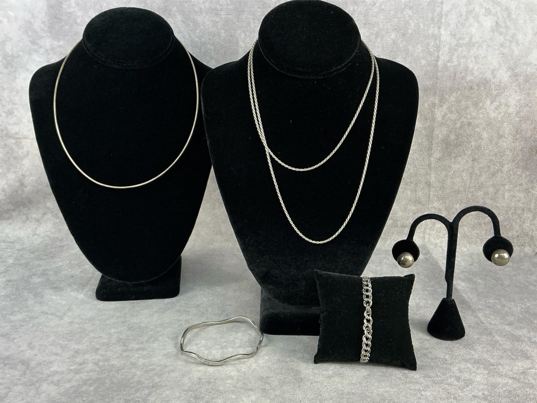 Sterling Silver Jewelry: Sterling silver jewelry including two necklaces, two bracelets and large stud earrings. All in good condition and stamped. Total weight 1.55 ozt.