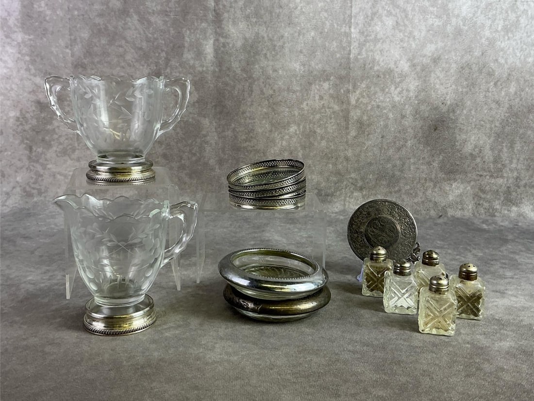 Sterling Trimmed Glassware: Sterling silver trimmed glassware finds including creamer, sugarer, coasters, ashtrays and more. All in good condition with oxidation present and stamped. Total weight including glass 35.59 ozt.