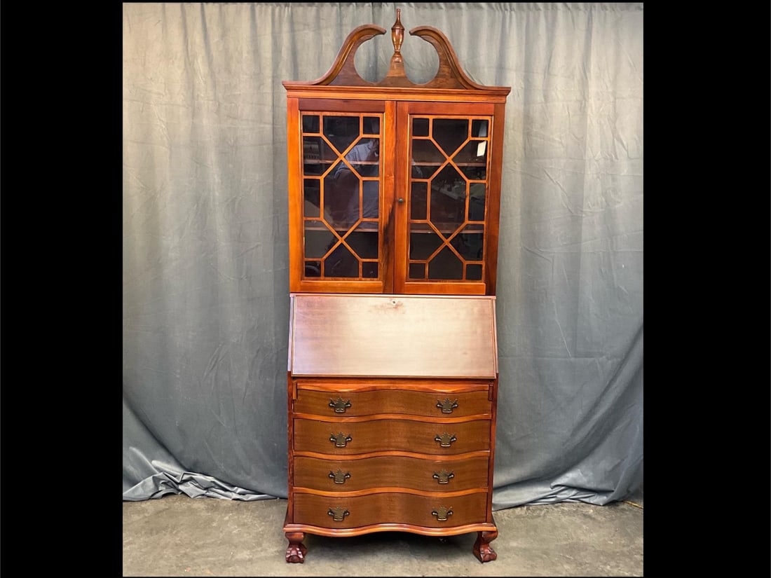 Chippendale Secretary: Mid-twentieth century Chippendale Style Mahogany Bookcase Desk/Secretary with slant front, divided interior, glazed doors, serpentine front, ball and claw feet, and swan neck pediment with urn