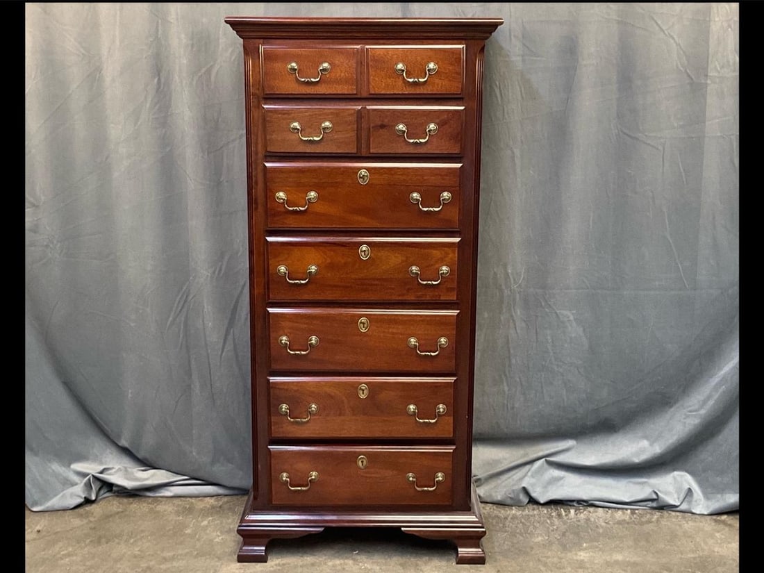High Chest of Drawers: Late 20th century Chippendale Style Mahogany High Chest of Drawers with bracket feet. Four small drawers over five drawers with brass bail handles. Manufactured by Kincaid Furniture. Good condition.