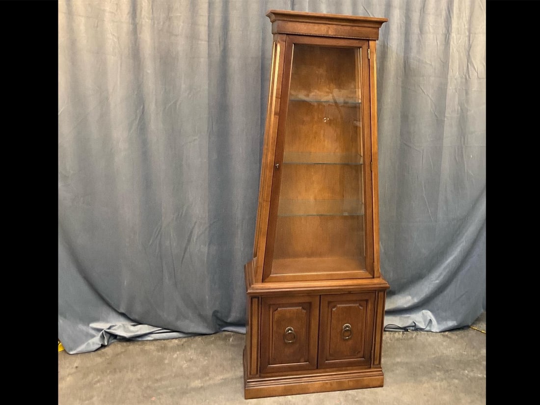Curio Cabinet: Late twentieth century Curio Cabinet with three interior glass shelves, storage area below with door doors, and working interior light. Good condition. Measures 25.5 inches wide x 13 x 67.75 inches