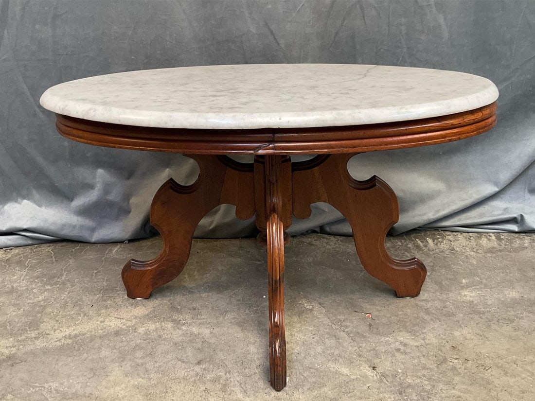 Eastlake Marble Table: Late 19th - Early 20th Century Eastlake Walnut Marble Top Side/Center /Coffee Table. Partial crack to top and loose joints, otherwise good condition. Measures 32.5 inches wide x 22.25 x 18 inches