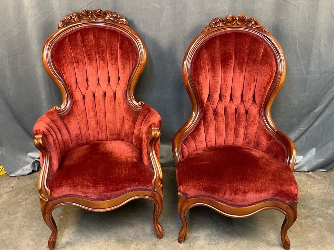 Victorian Chairs: Mid- twentieth century Victorian Style His and Her Armchairs. Carved floral crest with tufted red velvet upholstery. Good condition. Measures 24 inches wide x 29 x 41 inches tall.