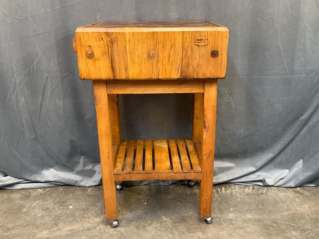 Chopping /Butcher Block: Late 20th century Wooden Butcher Block on castors with lower shelf. Maker's branded logo on side. Used, otherwise good condition. Measures 23 inches wide x 19 x 37 inches tall.