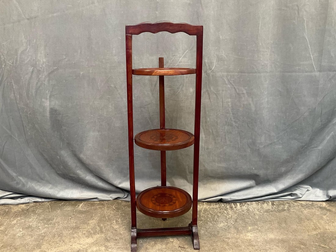 Wooden Pie Stand: Mid-twentieth century wooden three tier folding pie stand with carved geometric design on each stand. Good condition. Measures 11 inches wide x 10.25 x 34.5 inches tall.