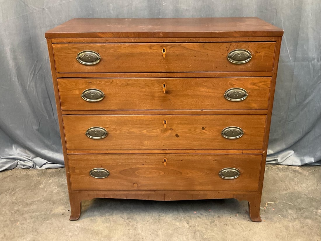 Chest of Drawers: Early 19th century Chest of Four Drawers with French Feet and Inlaid Escutcheons. Two drawer interior top drawer. Walnut with poplar interior and yellow pine backboards. Replaced period brass pulls