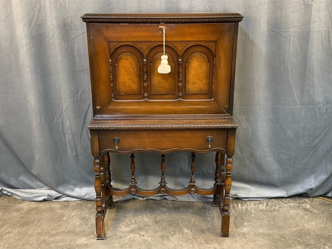 Fall Front Desk: Mid-20th century William and Mary Style Fall Front Walnut Desk with fitted interior. Working key. Missing one piece of half spindle trim to fall front facade, some scratches to finish, and overall