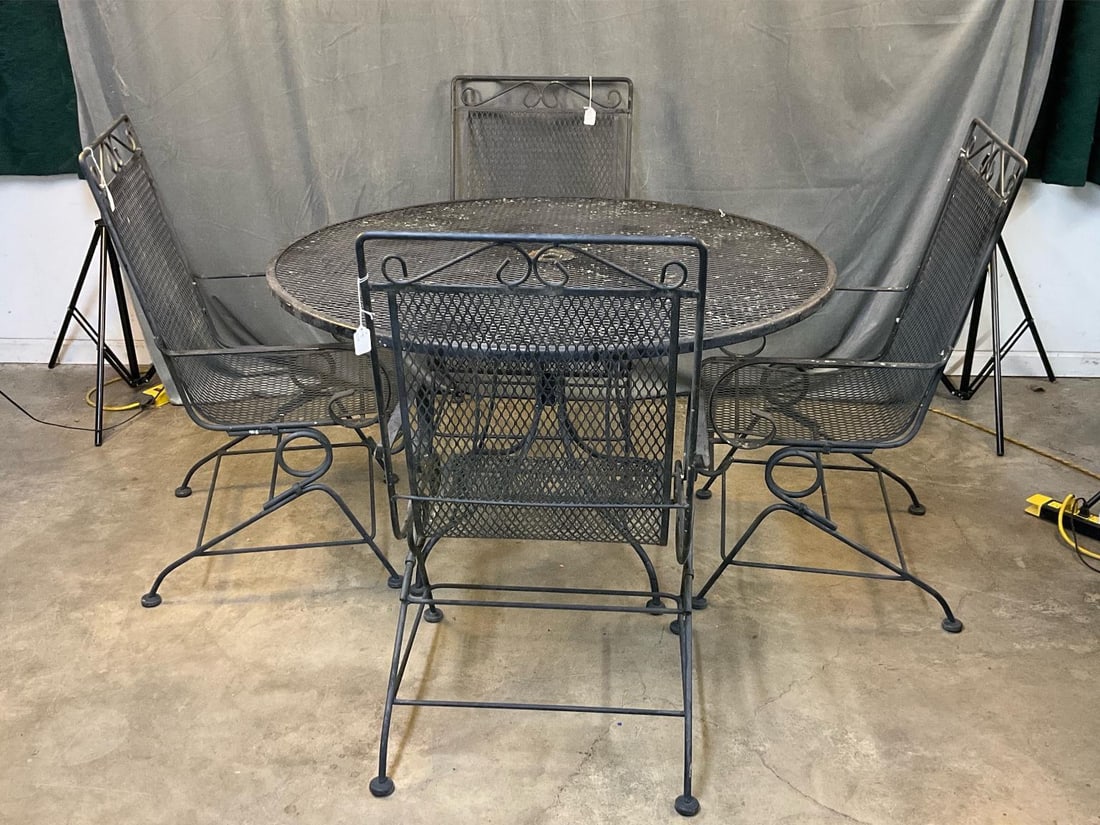 Outdoor Iron Table /Chairs: Late 20th century set of outdoor wrought iron table and four rocking armchairs. Used outdoor condition, otherwise good condition. Table measures 48.25 inches in diameter x 28.5 inches tall.