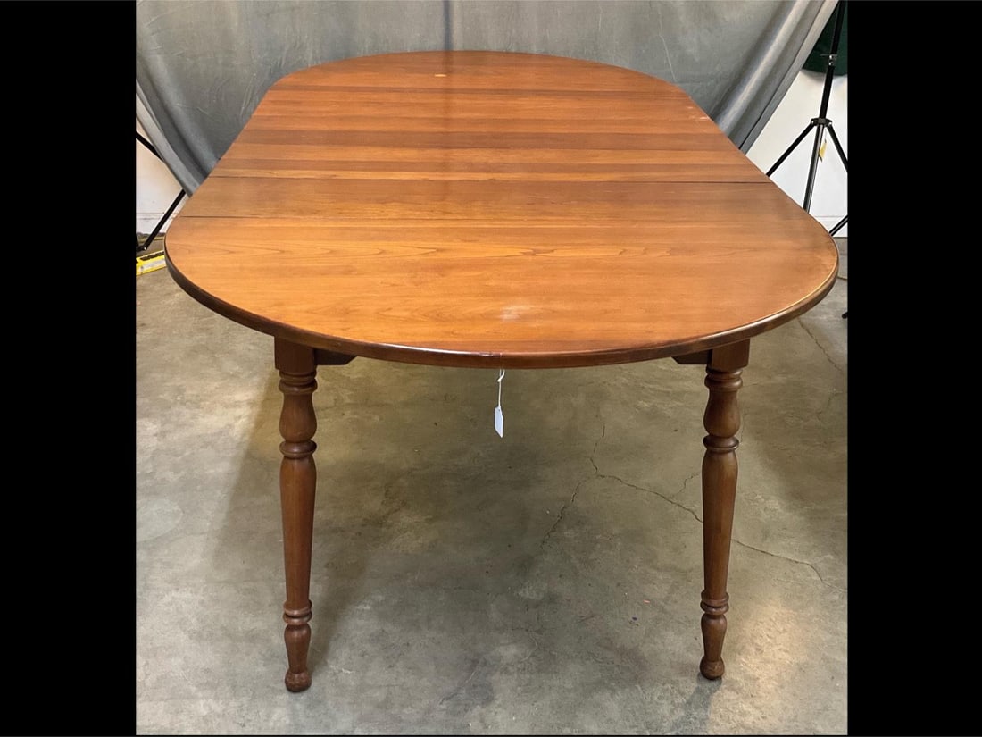 Dining Table: 1960's-1970's Sheraton Style Cherry Dining Table with four leaves. Some areas of finish loss and scratches, otherwise good condition. Measures 91.75 inches wide x 48 x 29.25 inches tall.