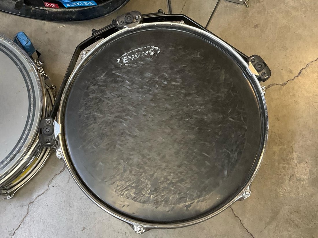 Drum Set: Incomplete Tama nine piece total drum set consisting of bass drum with decorative stickers and Pearl pedal, 12 and 13 inch toms, snare, floor tom, bottom half of hi hat stand, splash stand with no