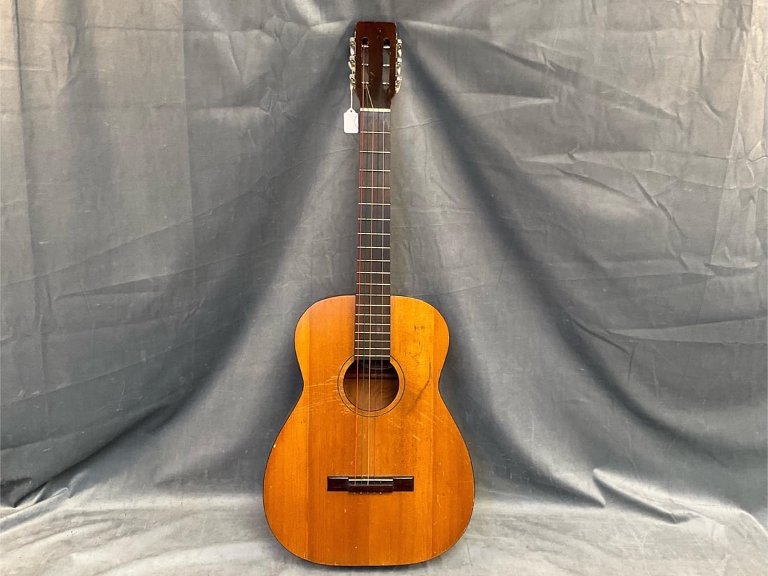 Classical Guitar: Circa 1960's Silvertone Classical Guitar F-64 WN. Some scratches to body and overall wear, otherwise good condition. Measures 38.5 inches wide x 14.75 x 3.75 inches tall.