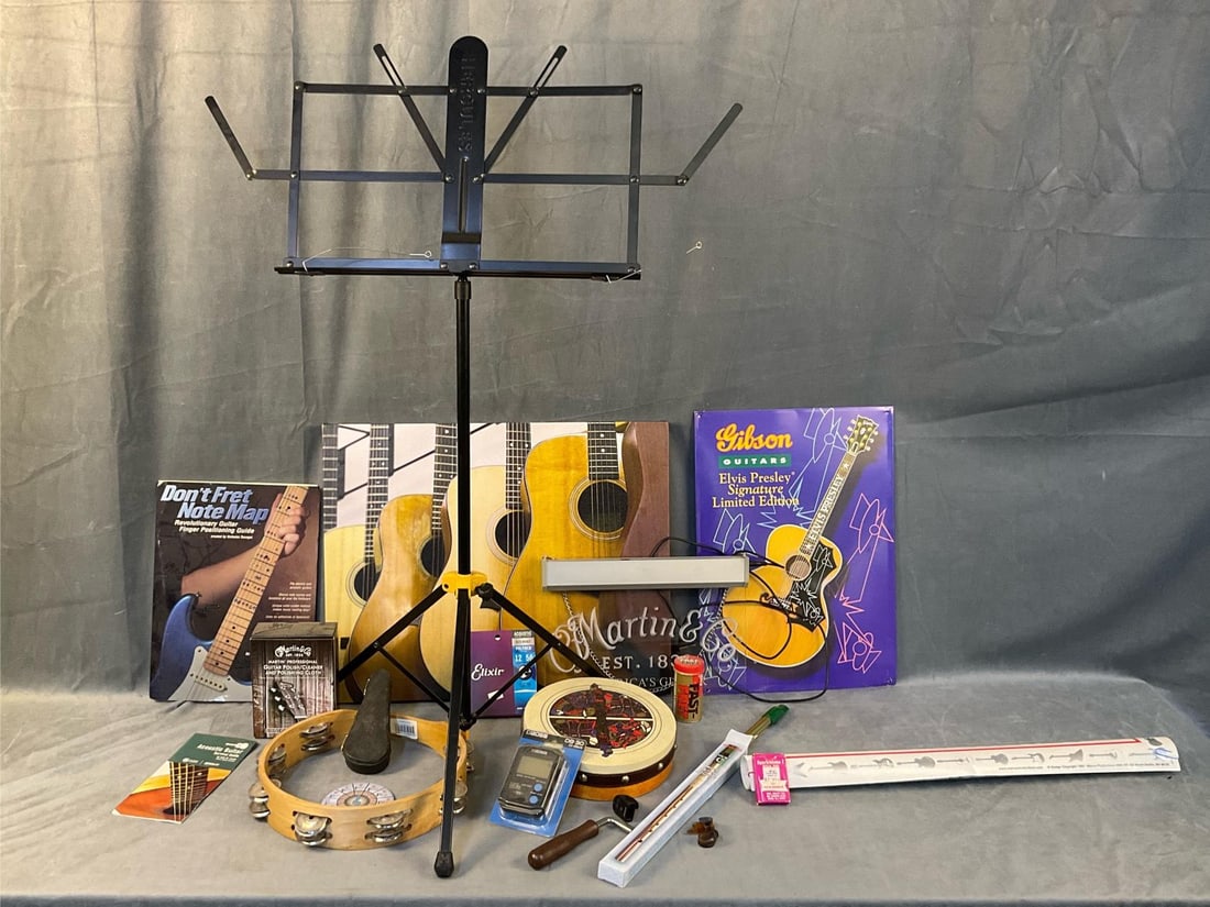 Assorted Musical Accoutrements: Modern/contemporary lot including; Hercules music stand, metal Gibson Guitar sign, print on canvas of guitars, Martin & Co. Guitar plexiglass advertising light up sign, Metronome unopened, Gaelic