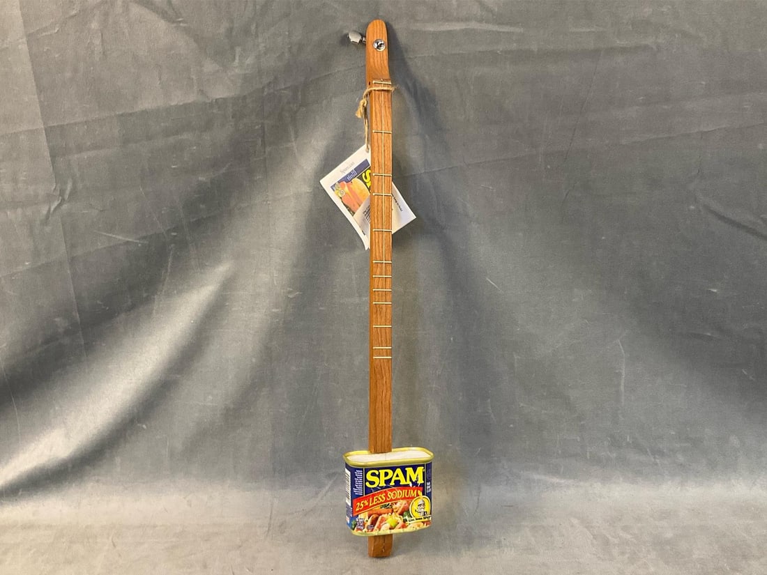 Spam "Can-Jo?? Dulcimer/Guitar: Modern/contemporary folk art hand made dulcimer like acoustic instrument. One string with Spam body and instruction booklet with song book. Made by Greg and Tish Westman. Good condition. Measures 25