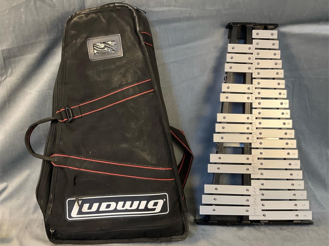 Ludwig Xylophone/Percussion Kit: Late twentieth century Ludwig Percussion Kit/Xylophone. Serial Number A233072. Includes two stands, three mallets, practice pad, and soft case bag. Measures 24 inches wide x 13.5 x 1.75 inches tall.