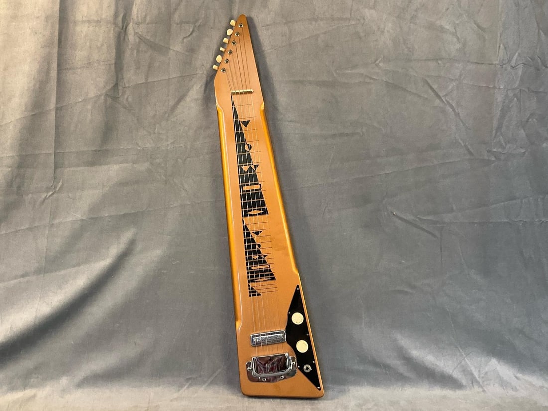 Harmony Lap Steel Electric Guitar: 1960's Lap Steel Six String Electric Guitar with soft case. Good condition, tested. Measures 6.75 inches wide x 2 x 34 inches tall.