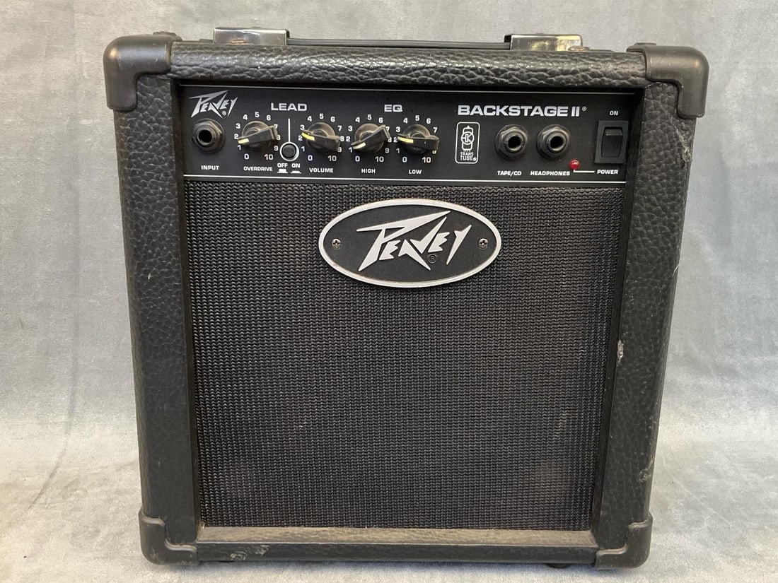Peavey Guitar Amplifier: Circa 2000 Peavey Backstage II Amplifier. Serial Number ENll 4012. Tested, good condition. Measures. 11.5 inches wide x 7 x 11.5 inches tall.