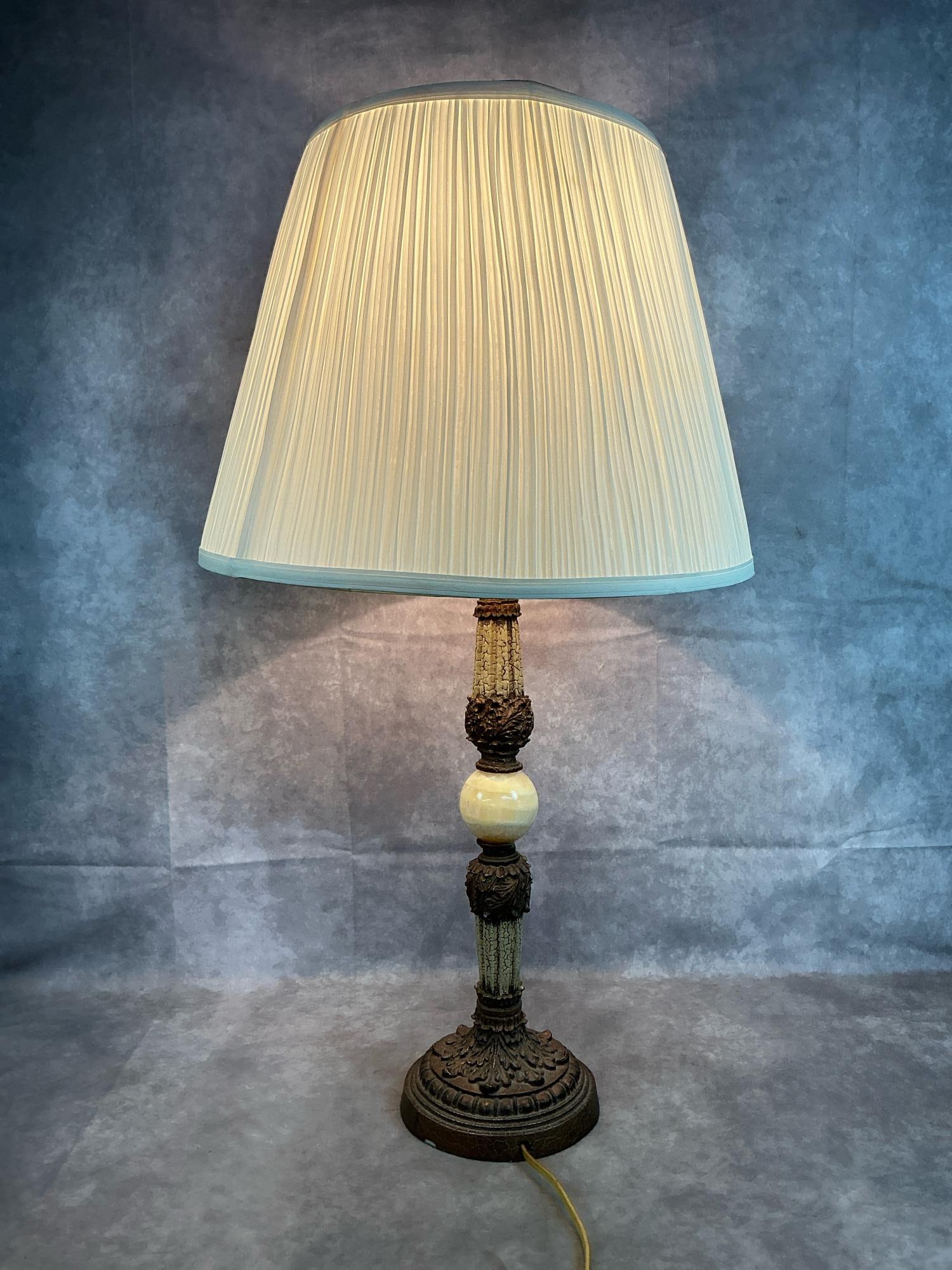 Hollywood Regency Lamp: Mid 1900's table lamp. Hollywood regency with alabaster orb and ornate accents. Shade is a bit out of round. Otherwise in good condition. Measures 6.5 inches at base x 33 inches tall.