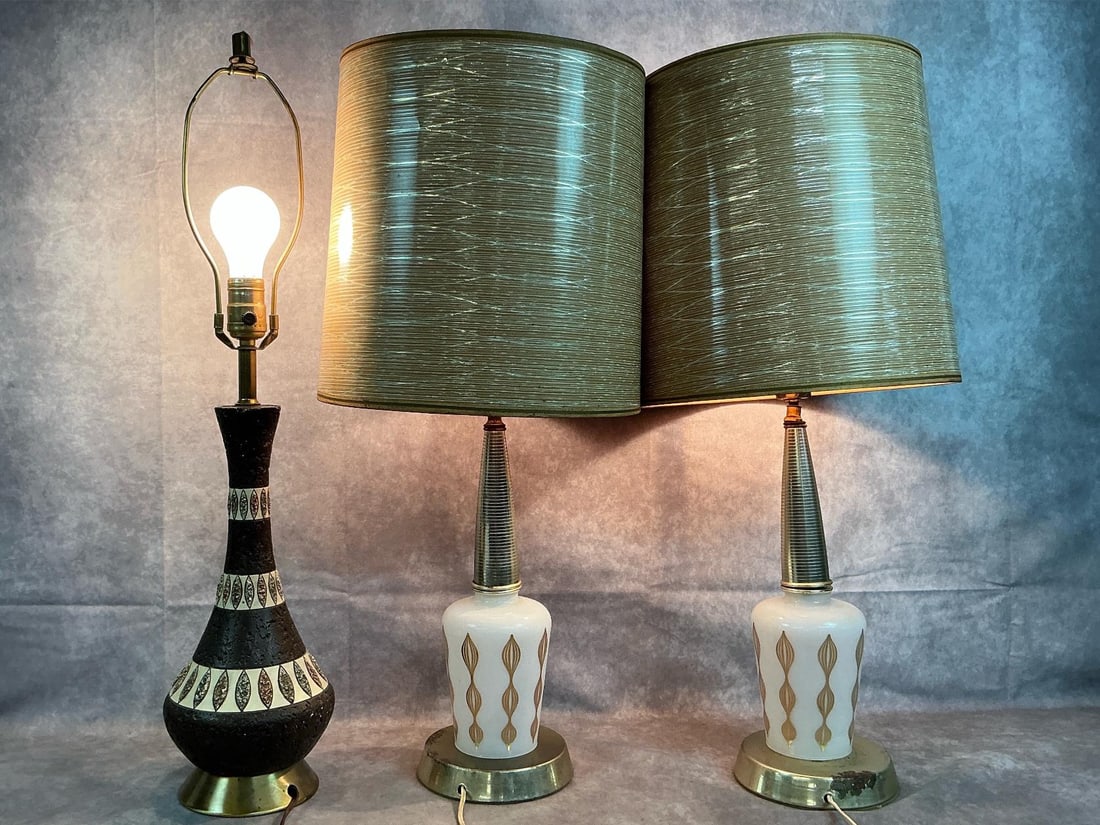 MCM Table Lamps: Three 1950's table lamps. Quartzite brown lamp (no shade), and two milk glass with gold accents lamps with shades. One of the milk glass lamps is very loose from the base with dented shade. Rust