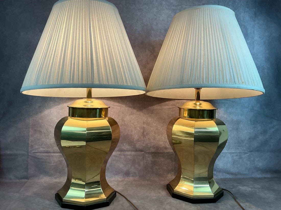 Brass Ginger Jar Lamps: Two Ethan Allen solid brass lamps. Octogonal shaped "ginger jar" table lamps with narrow black base. Shades are in fair condition, lamps in good condition. Each measures 9 inches wide at base x 32