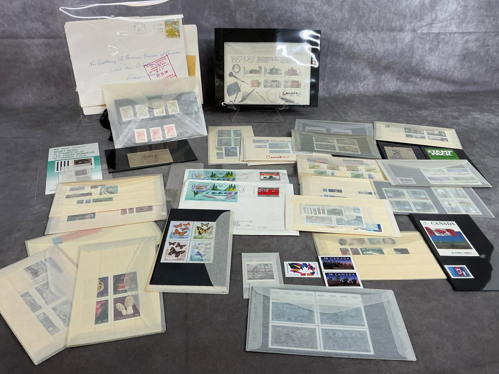 Canadian Stamps: Lot of late 1900's Canadian postage stamps. Varied collection from 1970's to 1990's. Varied denominations. Protected in glassine envelopes. Envelopes measure 6 inches wide x 3.5 inches tall.