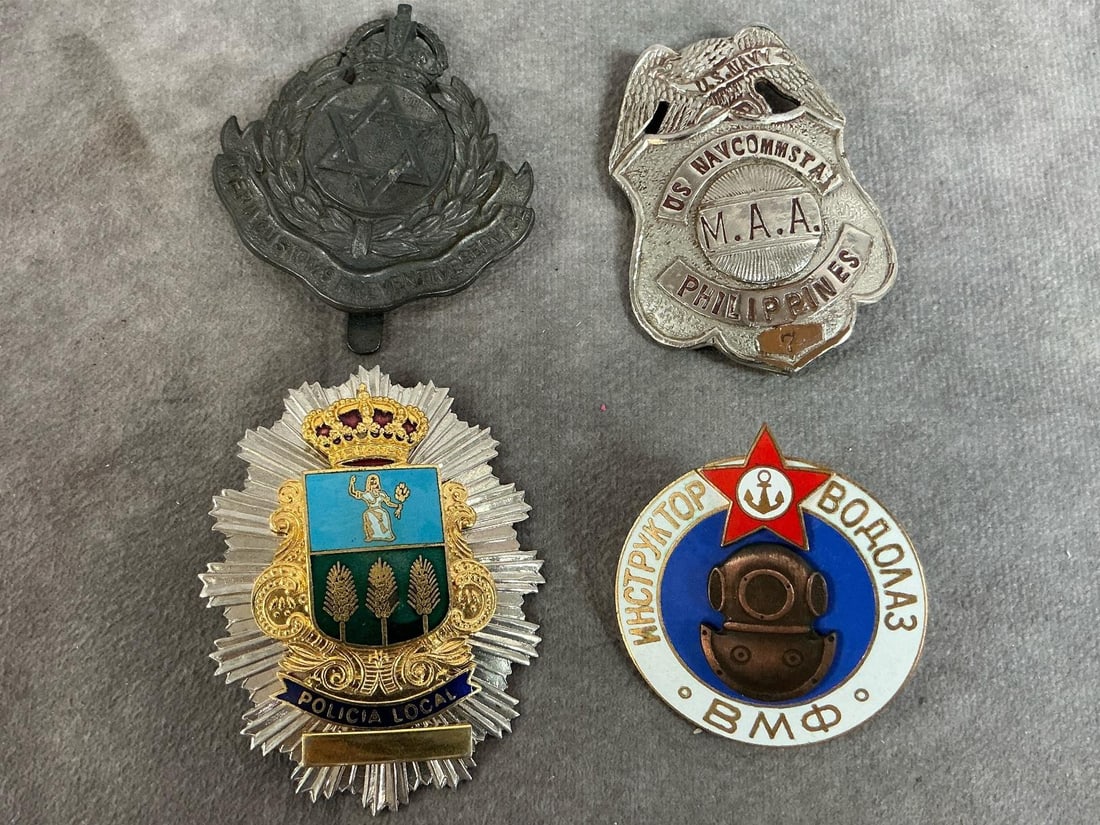 Foreign Country Badges: Four vintage badges. Spanish Local Police, Nigeria Customs cap badge, Russian Navy Diver Instructor badge, and US Navy/ Philippines badge. All in good condition. Spanish badge measures 2.25 inches