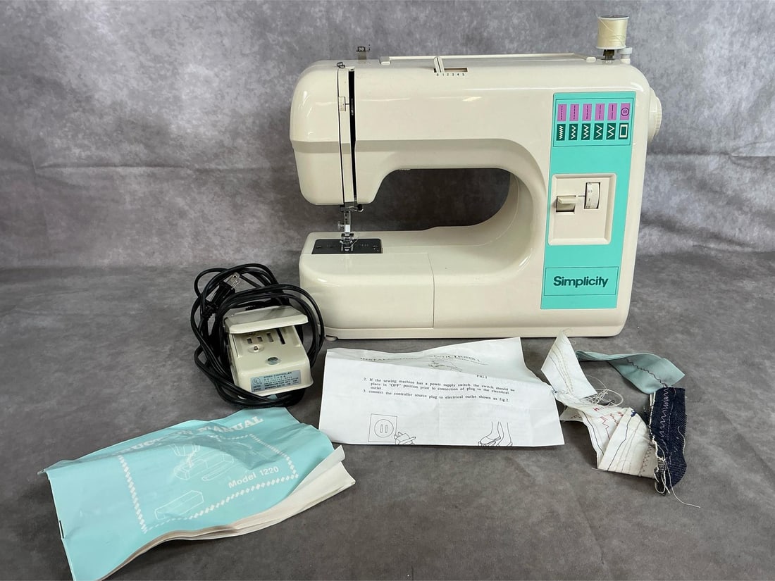 Simplicity Sewing Machine: Simplicity model 1220 sewing machine with foot pedal. Beginner friendly, cream with teal accent panel, with handle. Includes instructions manual. In good condition. Measures 14.5 inches wide x 6 x 12