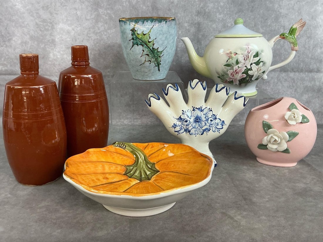Vases, Wine Bottles, & More: Seven mid to late 1900's items. Two brown Portuguese Lancer wine bottles, Lefton pink floral vase, Elpa Alcobacea five finger tulipiere vase in blue and white, hummingbird and lillies Teleflora
