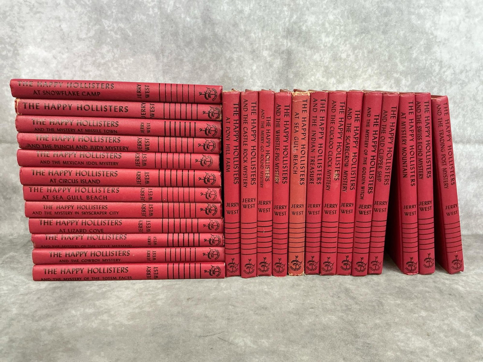 The Happy Hollisters Mystery Series: Twenty-five 1950's - 1960's hardcover books. The Happy Hollisters by Jerry West is for pre teen age children. Some foxing and yellowing present. Books measure 5.75 inches wide x 1 x 8.5 inches tall.