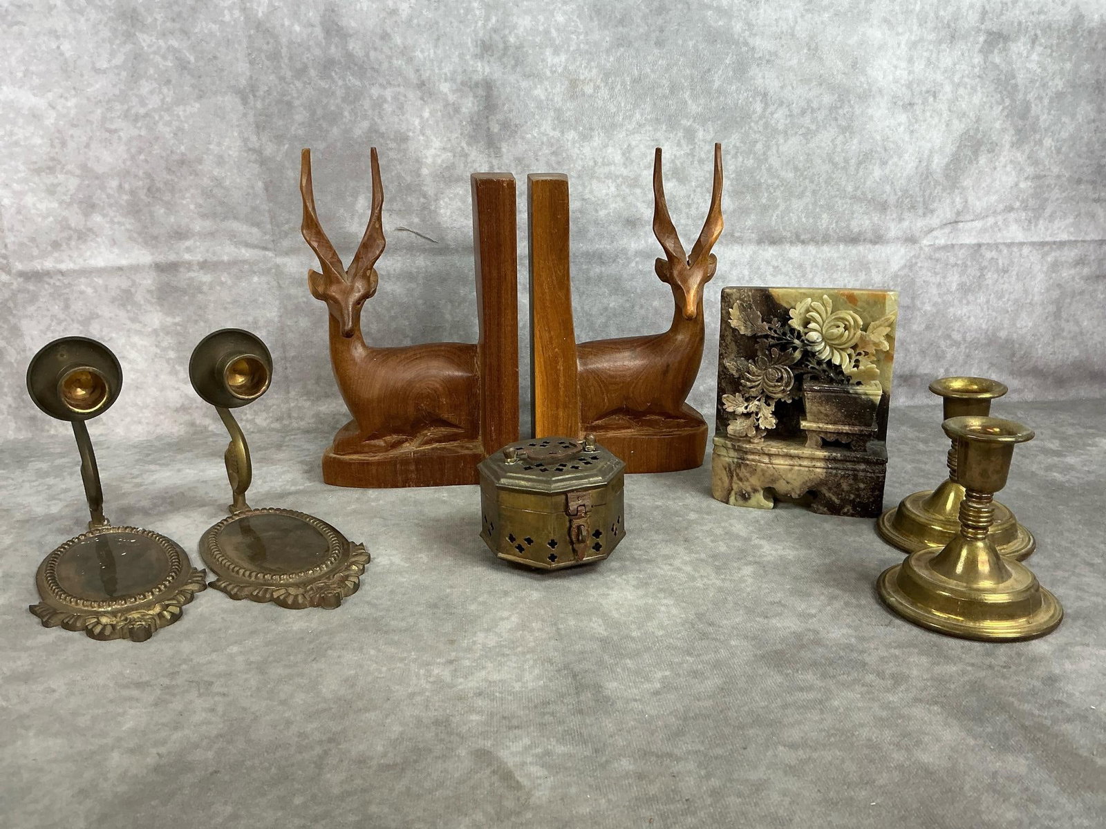 Brass, Soapstone, & Wood: Eight mid 1900's pieces. Gazelle bookends hand carved in Kenya, Chinese soapstone carved bookend, and brass cricket box, wall sconce candle holders, and table candle holders. Some tarnish present,