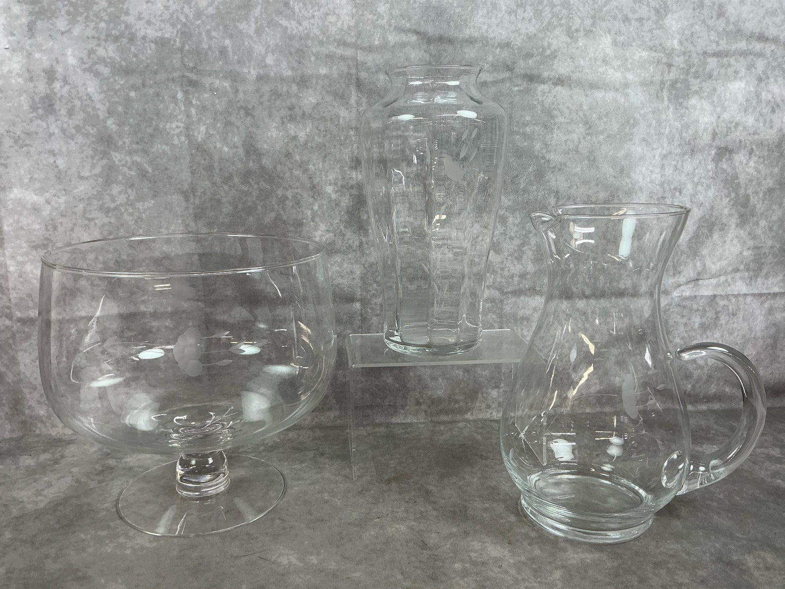 Princess House Heritage Glassware: Three late 1900's Princess House glass. Heritage pattern pedestal footed bowl, crystal pitcher, and crystal vase. In good condition. Bowl measures 9 inches in diameter x 9 inches tall.