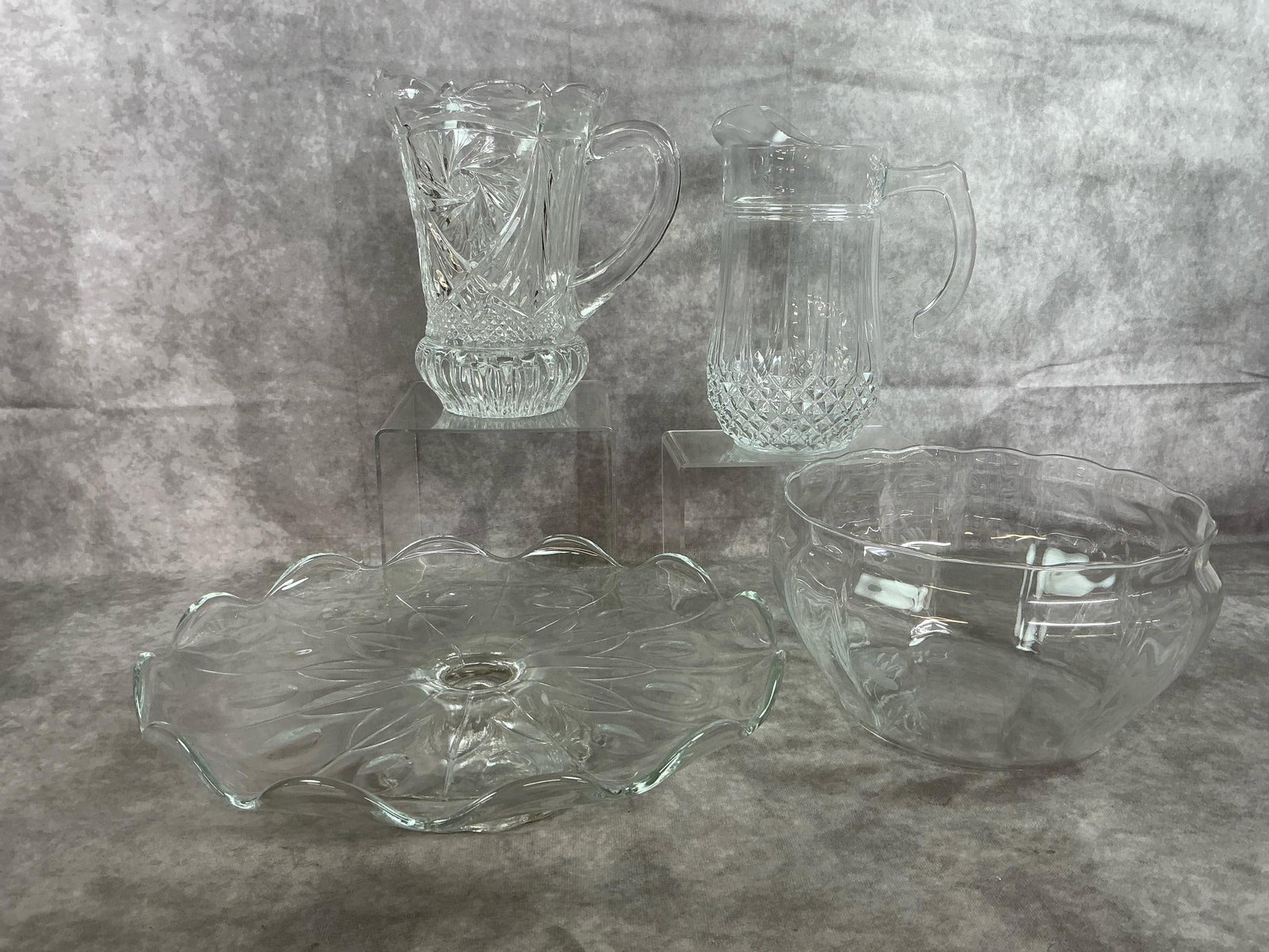 Crystal Glass Serving Pieces: Four late 1900's to modern age glass pieces. Princess House Heritage crystal pedestal cake stand and Arcoroc France clear dish with scalloped pattern. Cut crystal ornate pitcher with pinwheel and