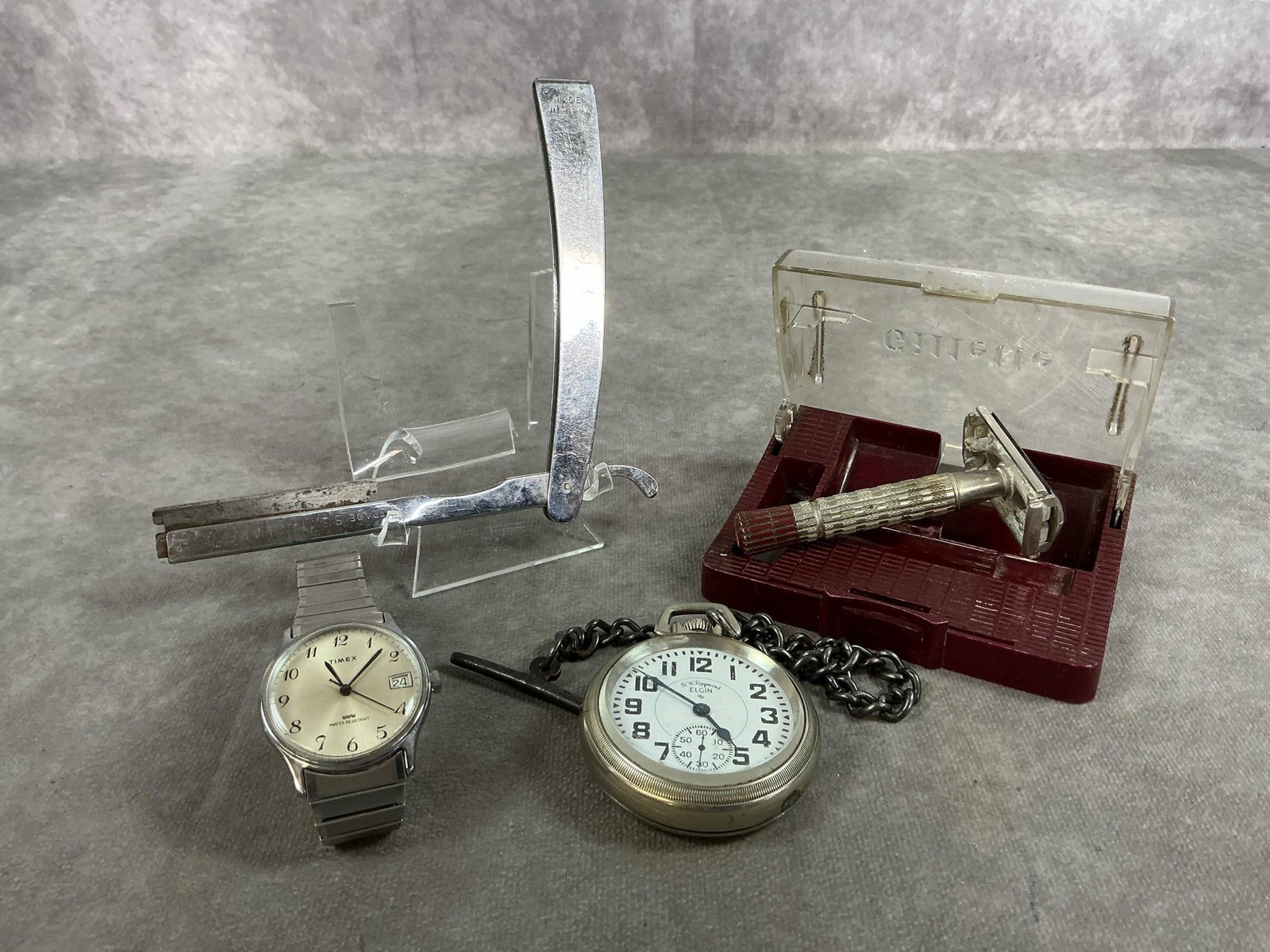 Vintage Razors & Watches: Four mid 1900's watches and razors. Gillette red tip safety razor and case, E Weck straight razor, Timex stretch band watch, and Elgin pocket watch in Keystone Nickeloid case. Slight rust on razors,