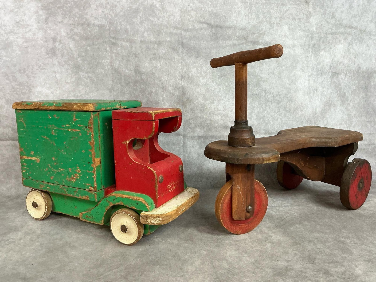 Vintage Wooden Truck & Tricycle: Mid 1900's wooden toys. Ride-on "Kiddie Kar" with wooden wheels and red and green handmade wooden truck. Paint loss and age related wear present. Tricycle measures 16 inches long x 6 x 13 inches tall.