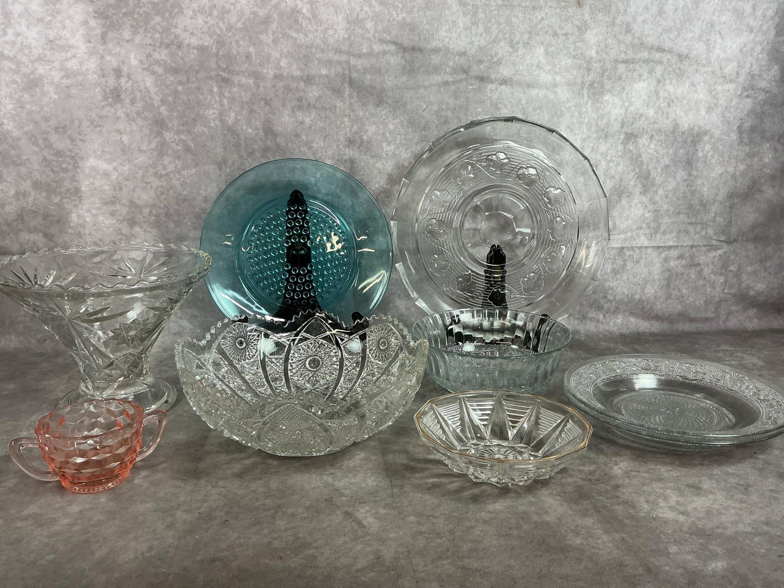 Glassware Collection: Nine mid to late 1900's glass serving pieces. AH Avalon clear floral serving tray, two shallow and a 3 inch tall Fleur de Lis pattern bowls, and Imperial Glass cut crystal Bellaire bowl. Includes AH
