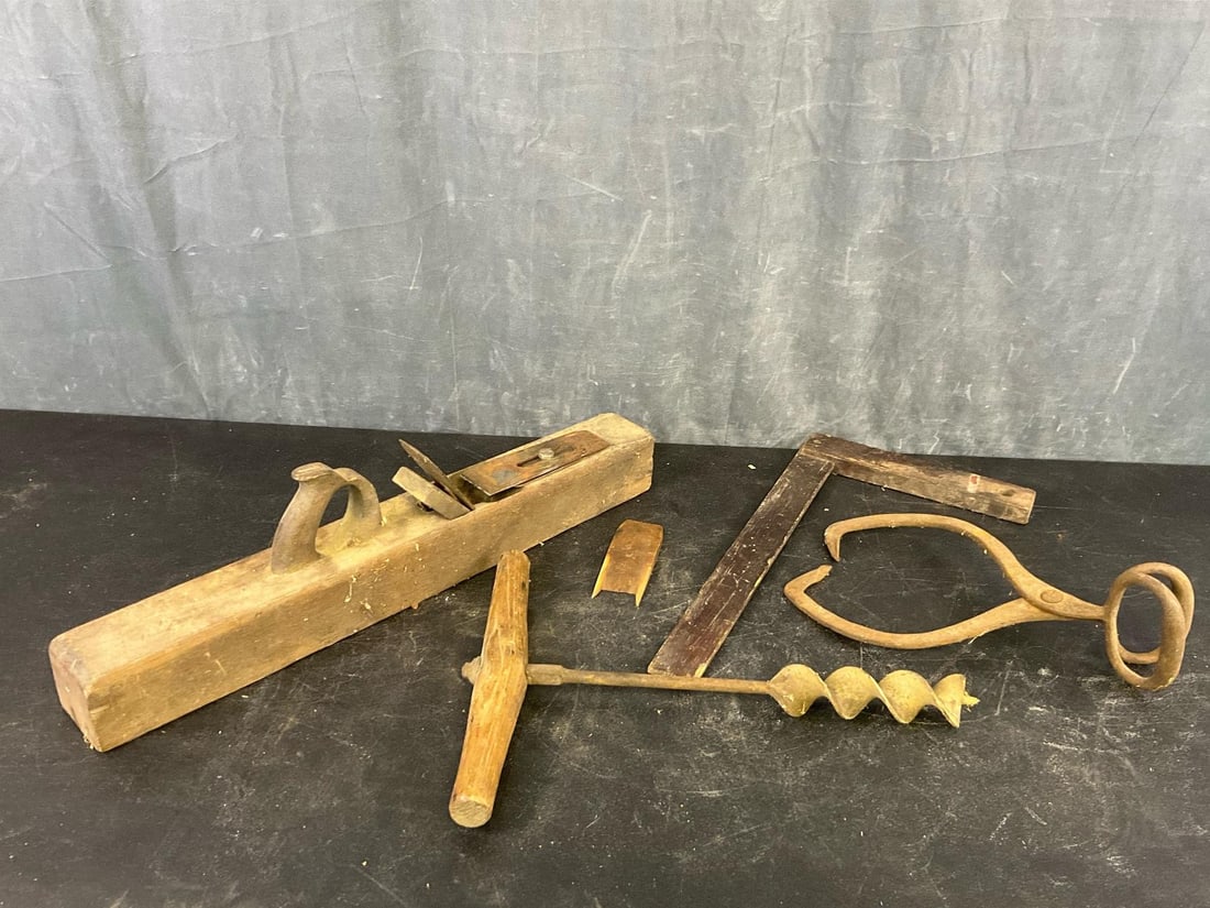 Hand Tools: Late 19th-early 20th century hand tools. One wooden hand plane, one ice tong, one square, and one hand auger. Good used condition. Hand plane measures 26.25 inches wide x 3.25 x 7 inches tall.