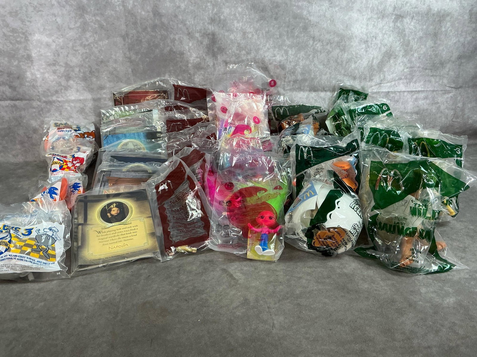 Happy Meal Collectibles: Fifty 1993-2006 McDonald's Happy Meal toys. Includes Sonic the Hedgehog, Narnia, Trollz, Chicken Little, and Disney's The Wild. In original packaging. Average package measures 4 inches wide x 6