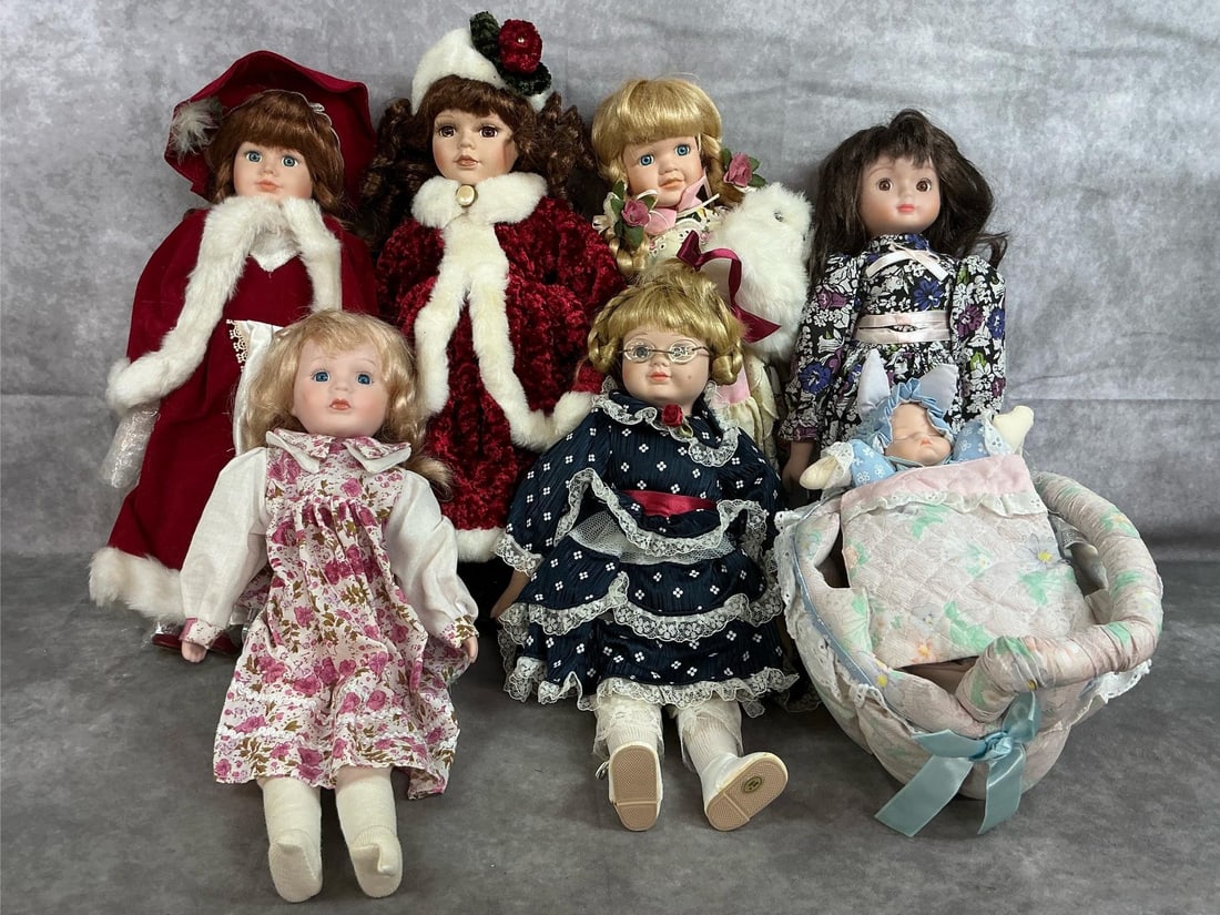 Collectible Dolls: Seven 1990's fine bisque porcelain dolls. Two Christmas dolls, a tiny baby doll in a basket cradle, two Victorian dressed dolls, and two floral dressed dolls. Slight wear from age. Christmas Doll