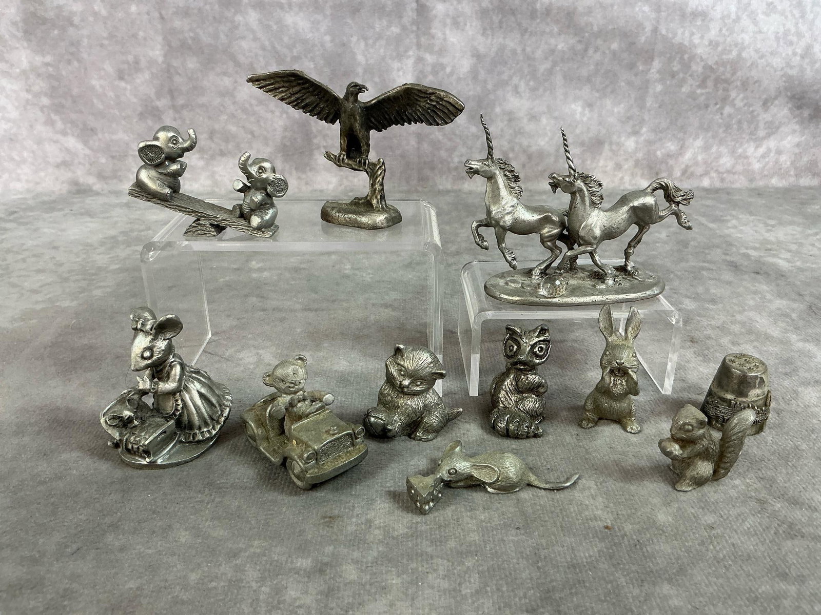 Miniature Pewter Animals: Eleven mid to late 1900's pewter figures. Includes unicorns, eagle, elephants, mouse, cat, raccoon and more. Slight tarnish. Unicorns measure 3 inches long x 1.25 x 2.25 inches tall.