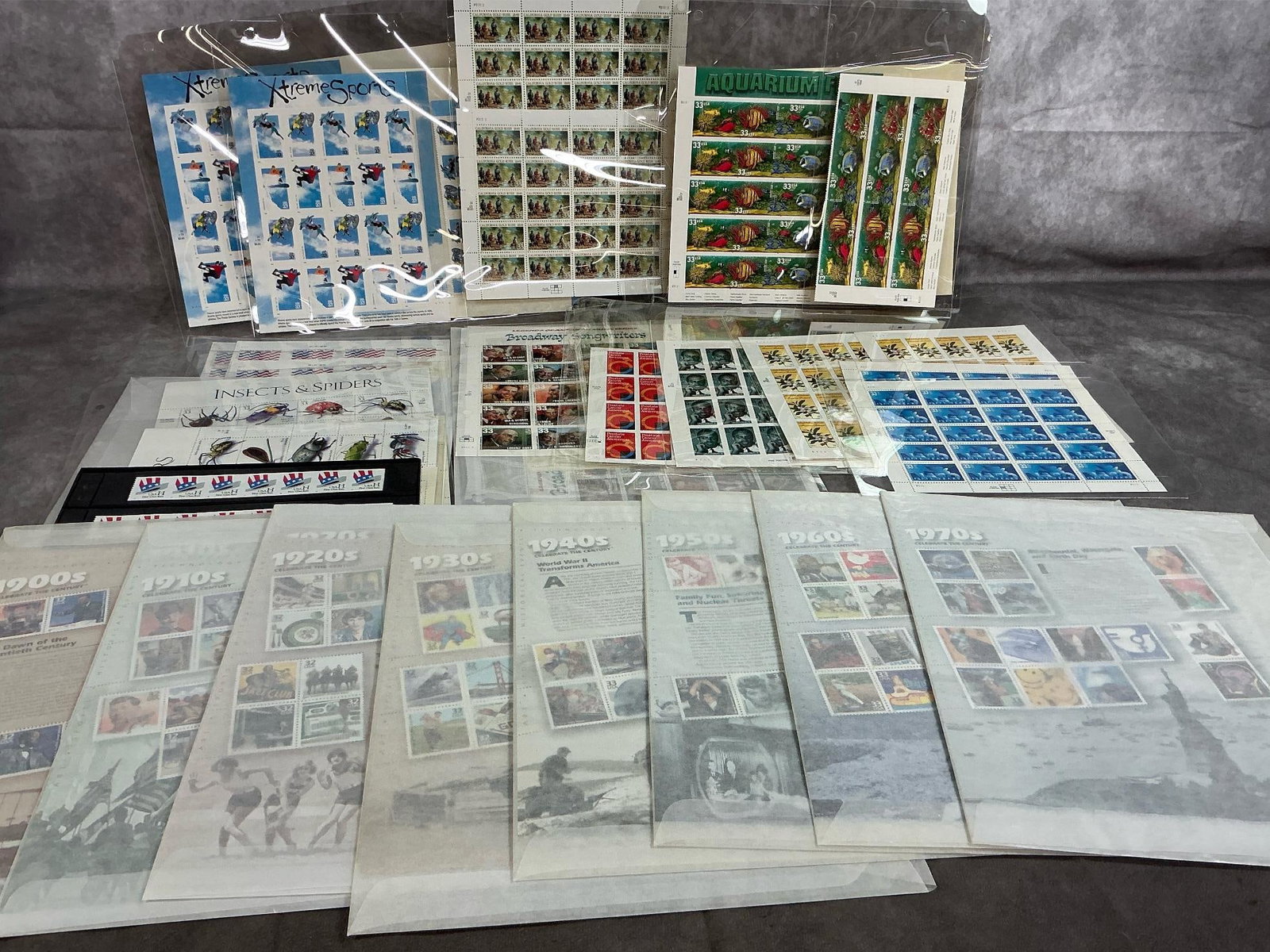 Collector's Stamps: Over 700 stamps from 1990's. Includes 32 cent and 33 cent stamps in sheets of 20 and 15 count. Well preserved in plastic and wax envelopes. Wax envelope sets measure 8.5 inches wide x 11 inches tall.