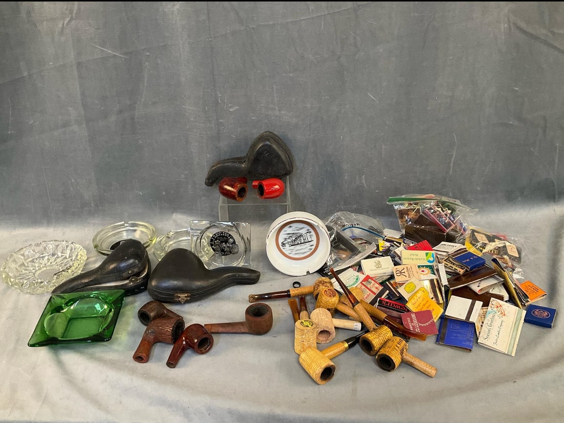 Tobacciana: Early-mid 20th century lot of vintage tobacco collectibles. Including; six glass ashtrays, approximately fifty matchbooks, eight corn Cobb pipes, five burled pipe bowls including Dr. Grabow and