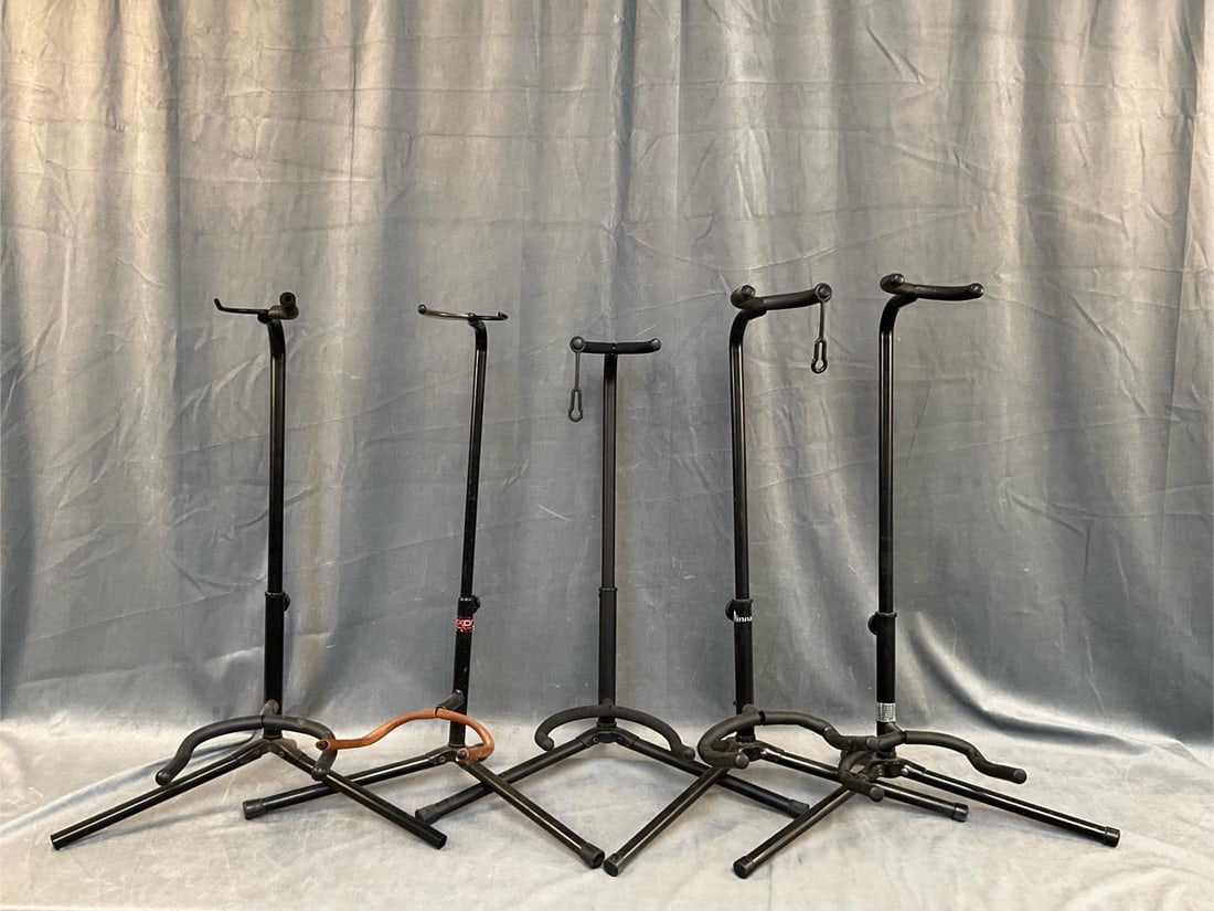 Guitar Stands: Five Contemporary Guitar Stands. One Pinnacle, one Dixon, three not marked. Good condition. Measures 19 inches wide x 12 x 28 inches tall.