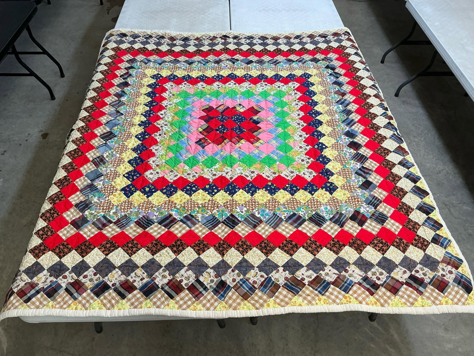 Homemade Quilt: Vintage Trip Around the World pattern quilt, machine stitched and hand quilted. A few small stains on the back, otherwise in good condition. Measures 66 inches wide x 74 inches long.