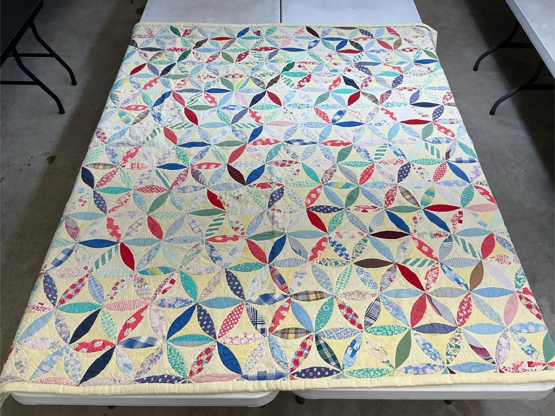 Homemade Quilt: Circa 1935 homemade quilt in the Joseph's Coat pattern. Quilt is machine stitched and uses feedsack material. Faded and has a few holes on the top. Measures 73 inches wide x 78 inches long.