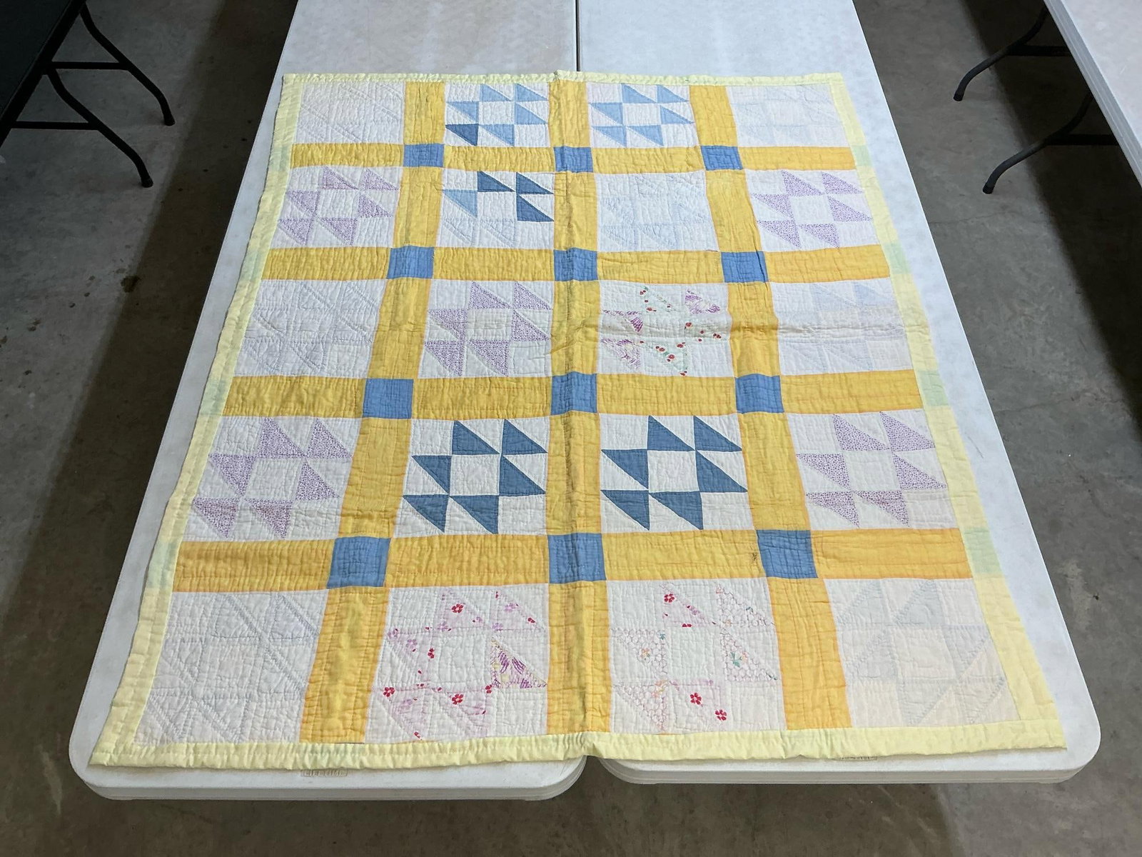 Child's Quilt: Vintage homemade child's size quilt, machine stitched and hand quilted. A few stains on front and back, otherwise good condition. Measures 54 inches wide x 67 inches long.