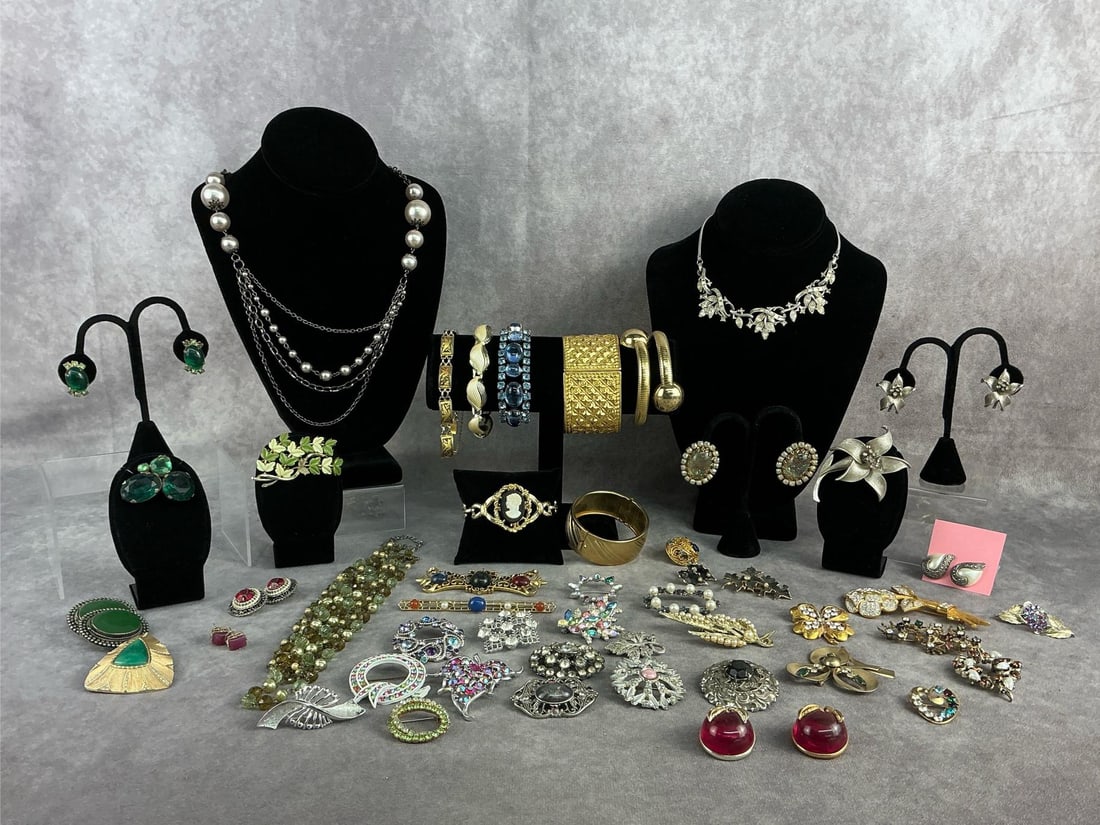 Costume Jewelry: Costume jewelry lot including three necklaces, seven bracelets, ten earrings, and twenty six brooches. All in good condition. Longest necklace measures 16 inches closed.