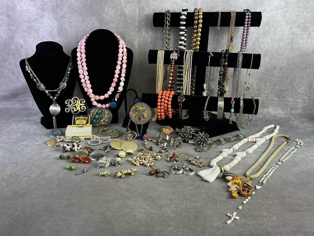 Costume Jewelry: Large lot of costume jewelry including necklaces, bracelets, brooches, earrings, and a belt buckle. All in fair to good condition. Longest necklace is 17 inches closed.