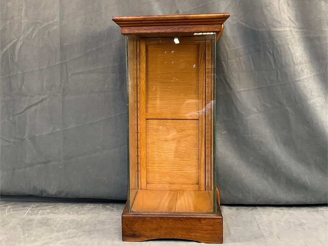 Country Store Display Cabinet: Circa 1900 American Oak Small Table Top Display Cabinet with crown-cornice moulding and bottom drawer. Good condition. Measures 11 inches wide x 10.5 x 24.25 inches tall.
