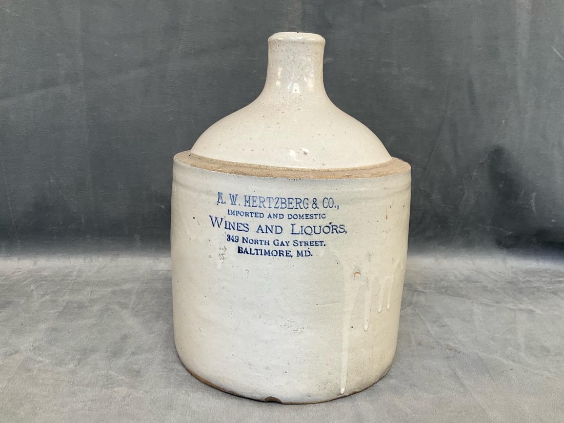Baltimore Advertising Stoneware Jug: Circa 1900 Baltimore, Maryland Liquor Merchant's Advertising Stoneware Jug. Bristol slip glazed and decorated with the cobalt blue stenciled advertising ""A.W. HERTZBERG & CO., / IMPORTED AND